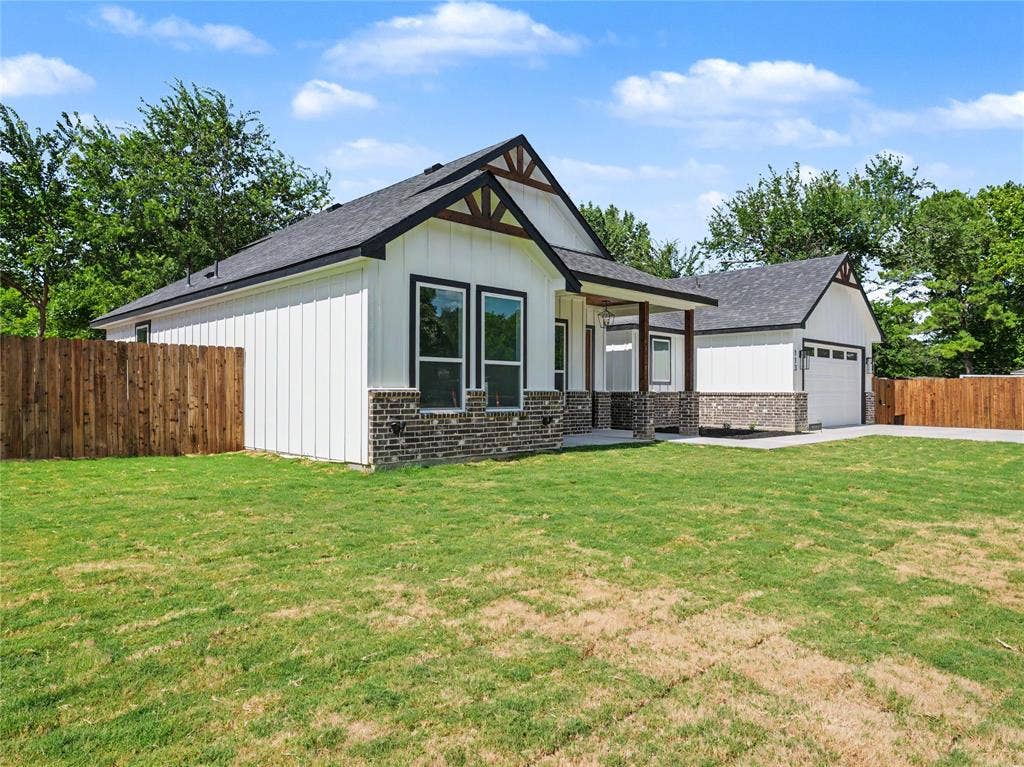 113 Dennis Drive, Azle, TX 76020 Modern farmhouse exterior featuring white vertical siding, dark brick accents, and a covered porch