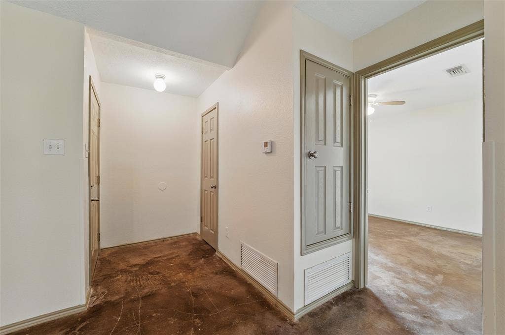Corridor with unfinished concrete flooring