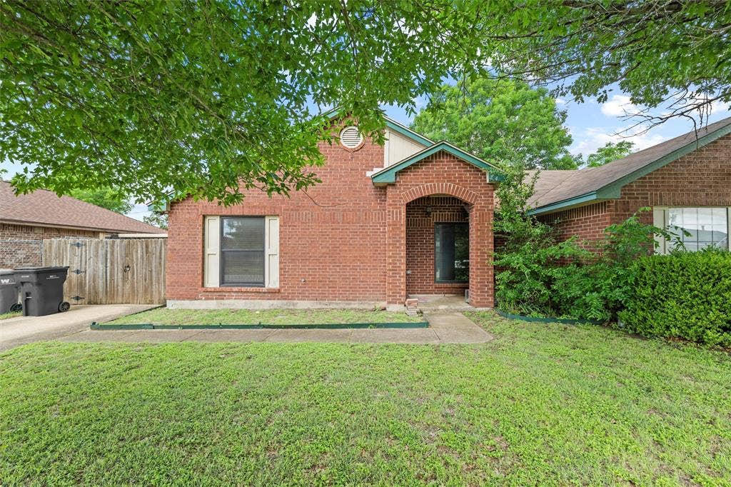 Traditional-style house with brick siding