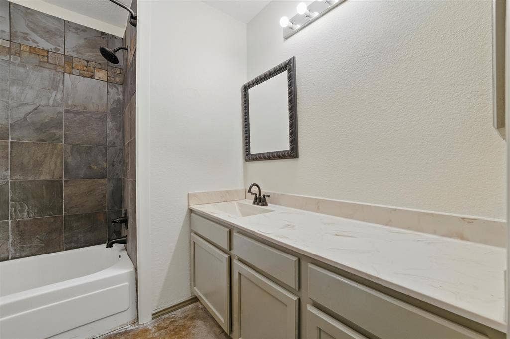 Bathroom with vanity and bathing tub / shower combination