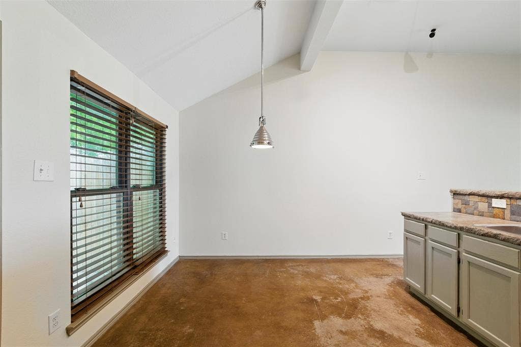 Unfurnished dining area featuring unfinished concrete floors