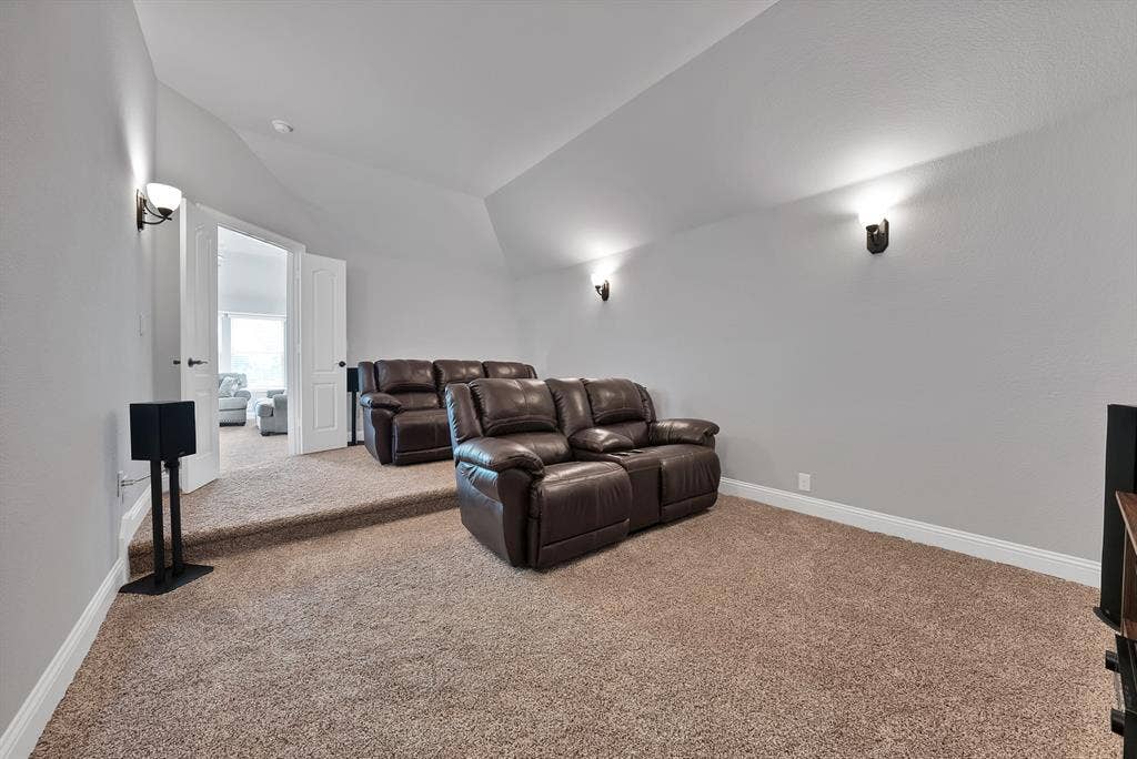 Multi-level room with neutral carpeting and light gray walls