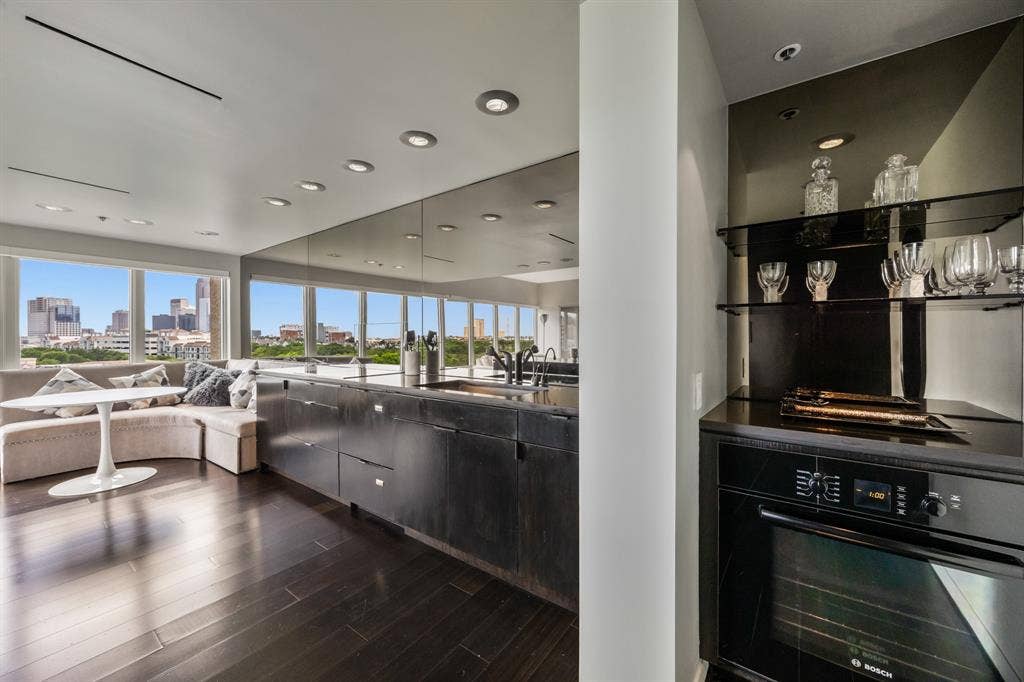 3030 Mckinney Avenue, #701, Dallas, TX 75204 Dedicated dry bar with glass display shelving and a built-in Bosch oven.