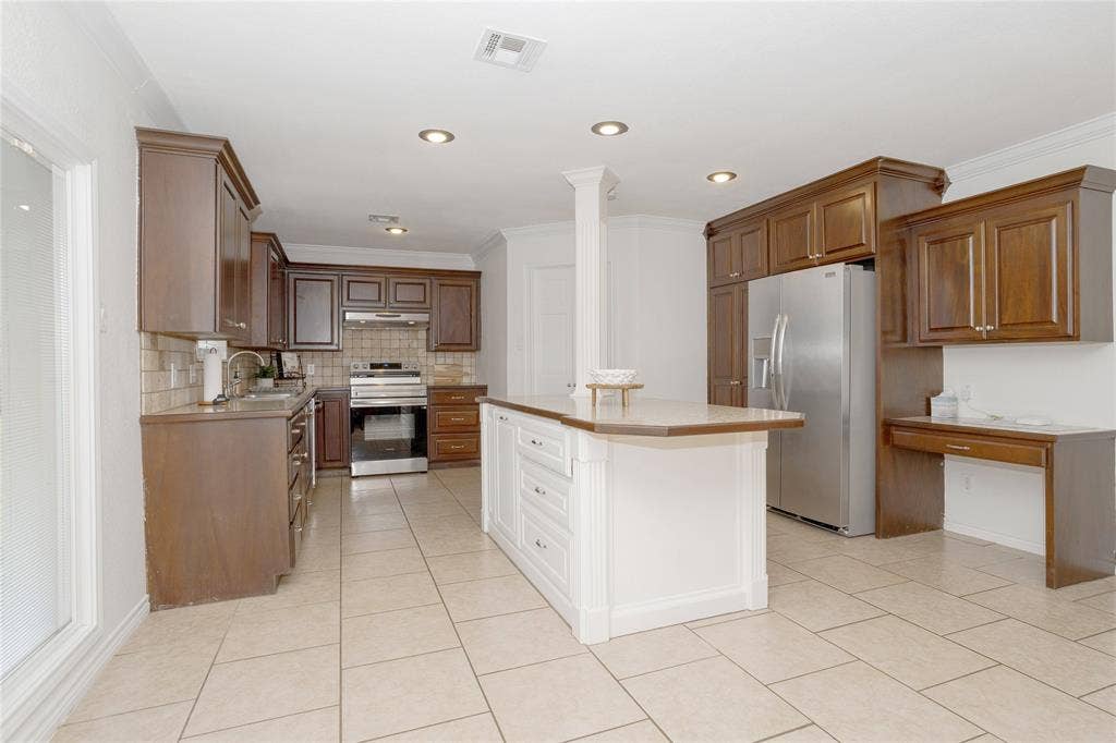 3999 Speegleville Road, Waco, TX 76712 Another view of the kitchen, showing the island and Frigidaire Gallery refrigerator that stays.