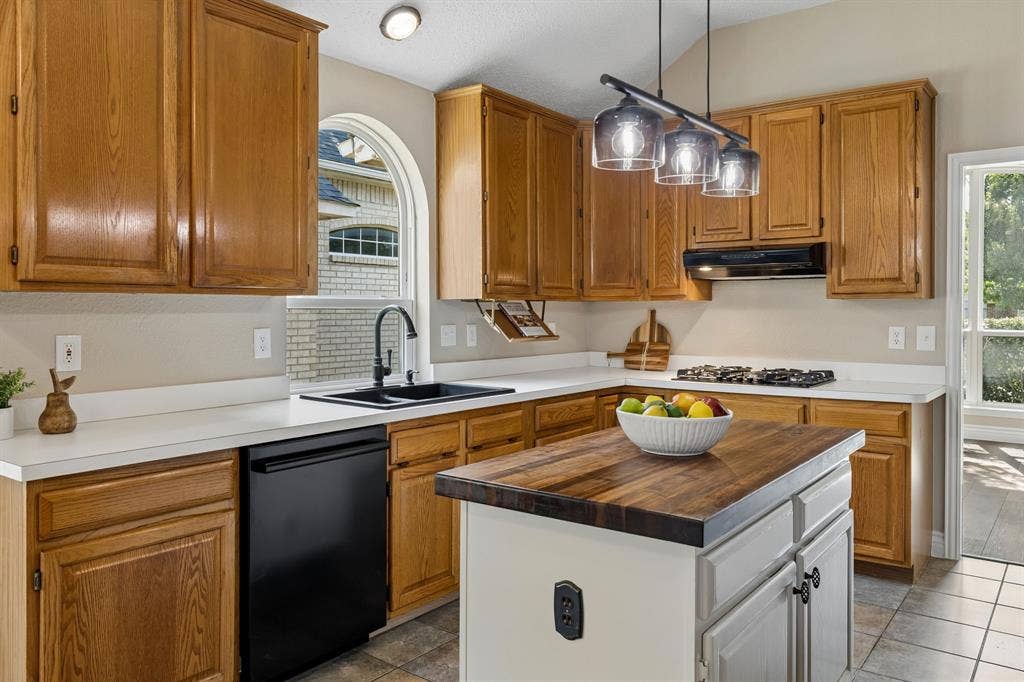 607 Grimsworth Court, Allen, TX 75002 The large kitchen offers wonderful storage with42in cabinets, pantry and storage in the freshly painted island.