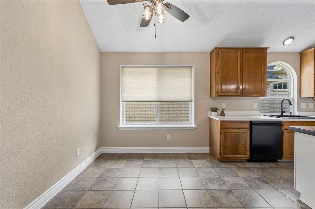 607 Grimsworth Court, Allen, TX 75002 The breakfast nook has wonderful light for the large window with window seat, ceiling fan and tile flooring.