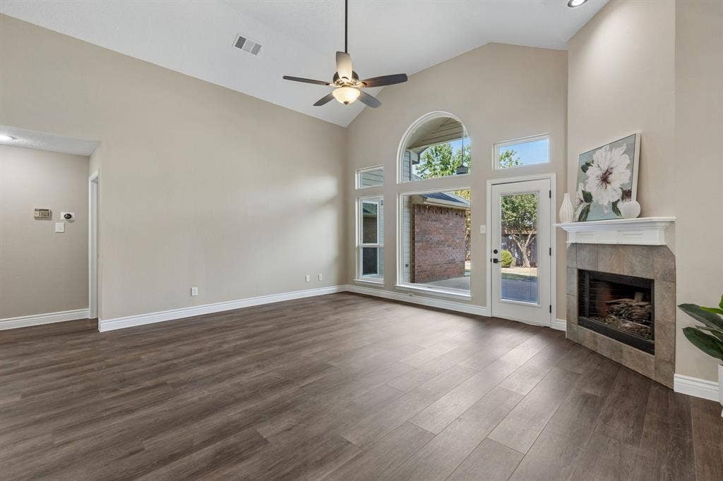 607 Grimsworth Court, Allen, TX 75002 The spacious living room has high ceilings, fresh paint, new LVP flooring,and new ceiling fan.