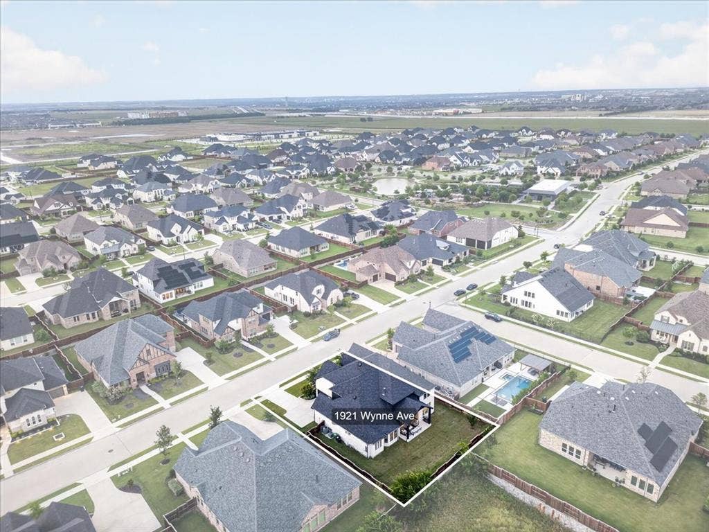 Aerial overview of a suburban neighborhood featuring numerous single-family residences