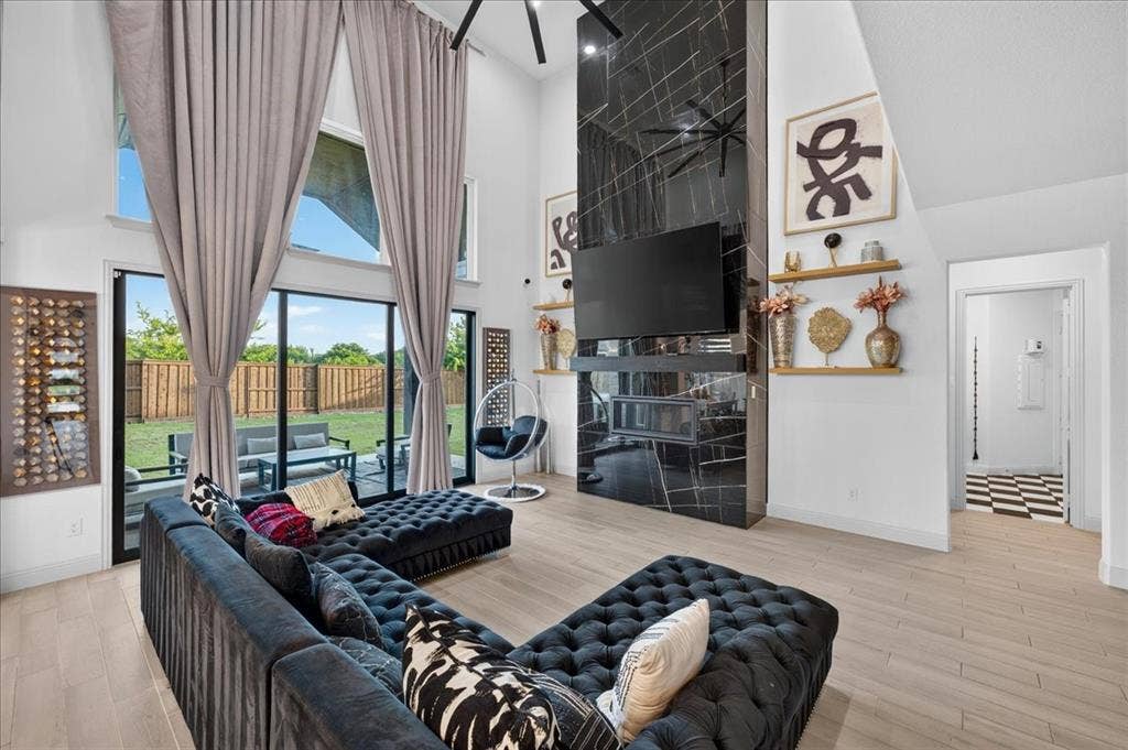 Living area featuring double-height ceilings and tall windows