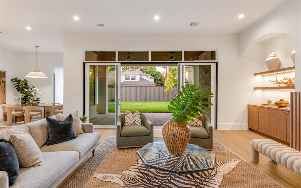 Open-concept living space with light-tone wood-finish flooring