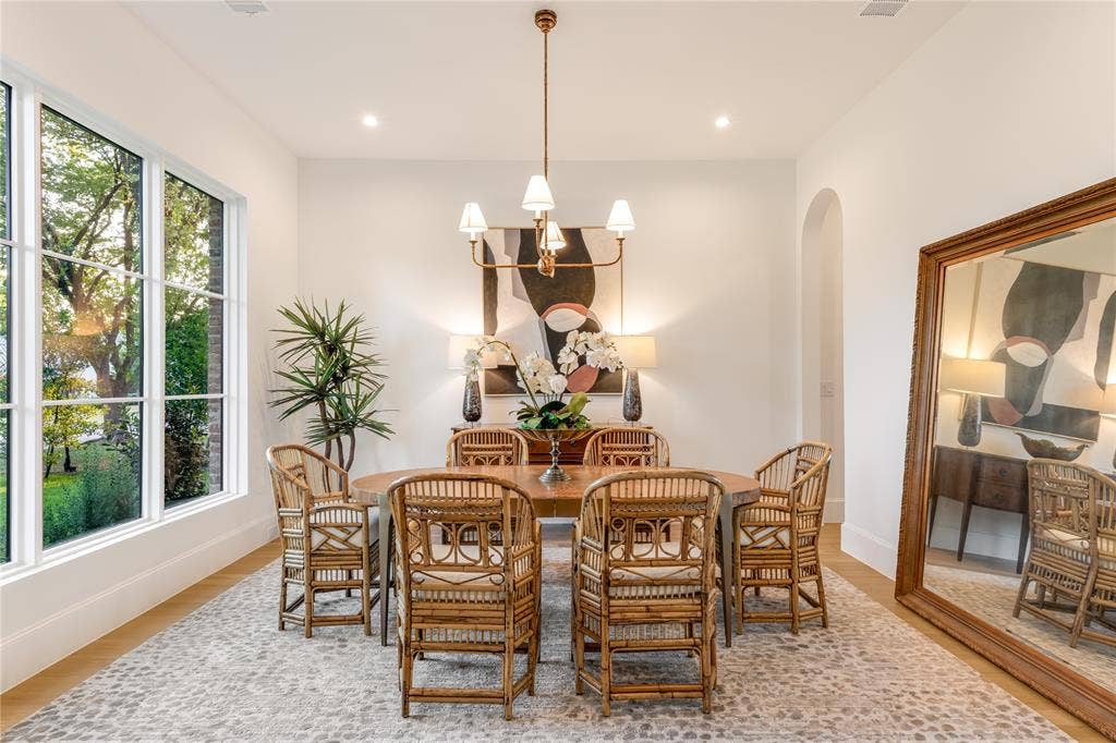 Spacious room featuring large gridded windows, recessed lighting, and a chandelier