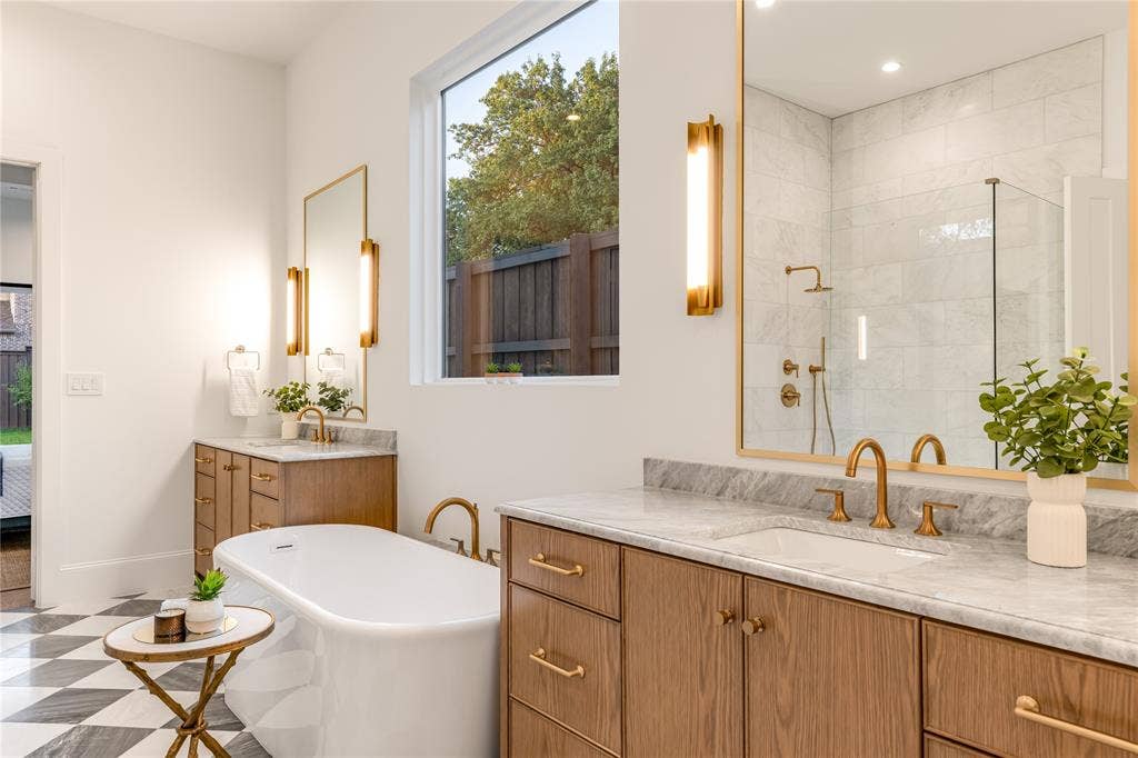 Freestanding soaking tub with gold-finish fixtures