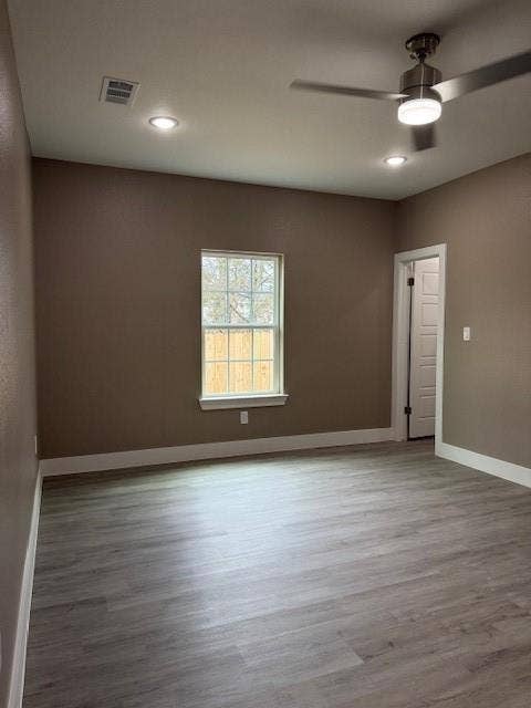 3513 Tomahawk Drive, Granbury, TX 76048 Spacious room featuring wood-finish flooring, recessed lighting, and a contemporary ceiling fan