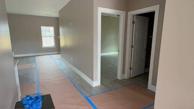 3513 Tomahawk Drive, Granbury, TX 76048 Interior space featuring light wood-finish flooring, neutral-toned walls, white trim, and a window with natural light