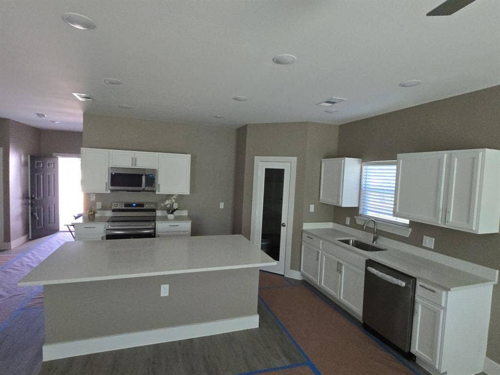 3513 Tomahawk Drive, Granbury, TX 76048 Contemporary kitchen featuring white cabinetry, light-toned countertops, and stainless steel appliances