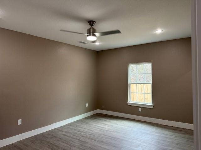 3513 Tomahawk Drive, Granbury, TX 76048 Room featuring wood-finish flooring, a double-hung window, white baseboards, a ceiling fan with integrated lighting, and recessed ceiling lights