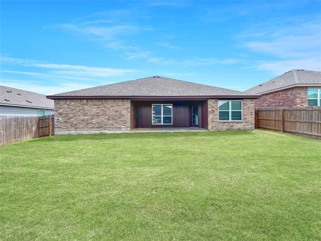 1210 Campbelton Drive, Temple, TX 76504 Expansive green lawn with a covered patio, brick exterior, and full privacy fencing