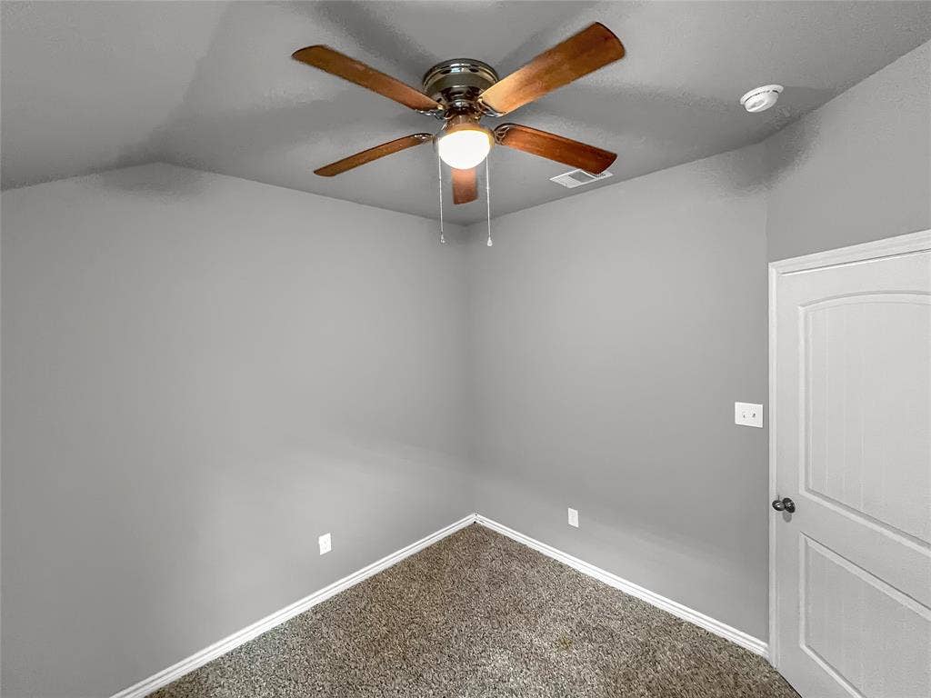 1210 Campbelton Drive, Temple, TX 76504 Room featuring a ceiling fan with wood-finish blades and integrated lighting, gray wall paint, and textured carpet flooring
