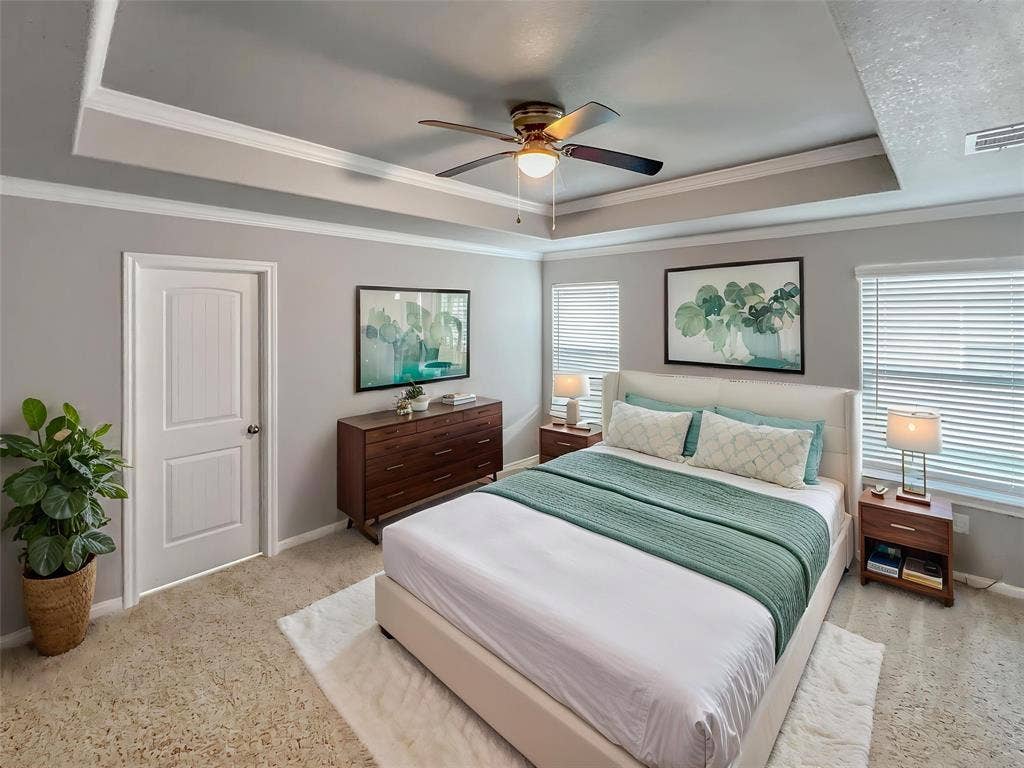 1210 Campbelton Drive, Temple, TX 76504 Virtually stagedRecessed tray ceiling with crown molding, ceiling fan, carpet flooring, multiple windows with blinds, and a white panel door
