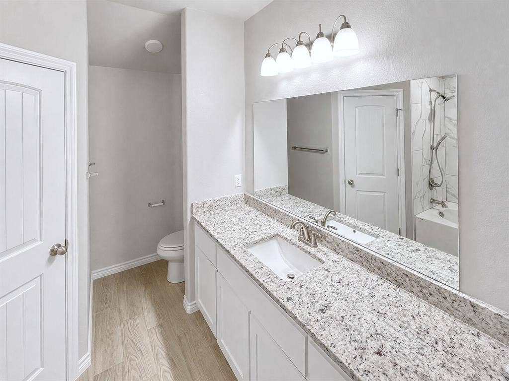 1210 Campbelton Drive, Temple, TX 76504 Bathroom vanity featuring a single undermount sink, brushed nickel faucet, and a granite countertop