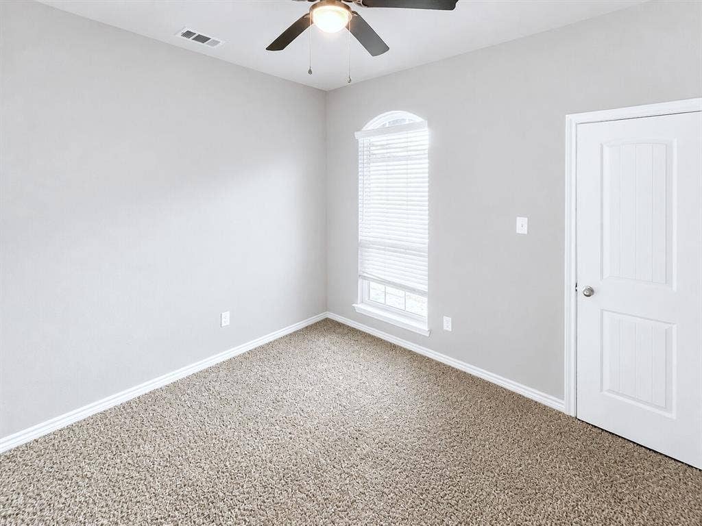 1210 Campbelton Drive, Temple, TX 76504 Carpeted interior space with light gray walls, white trim, and a white paneled door