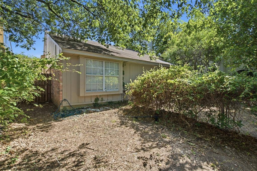 1106 Cain Court, Cedar Hill, TX 75104 Exterior residential structure with tan siding, a brown shingle roof, and a prominent multi-pane window