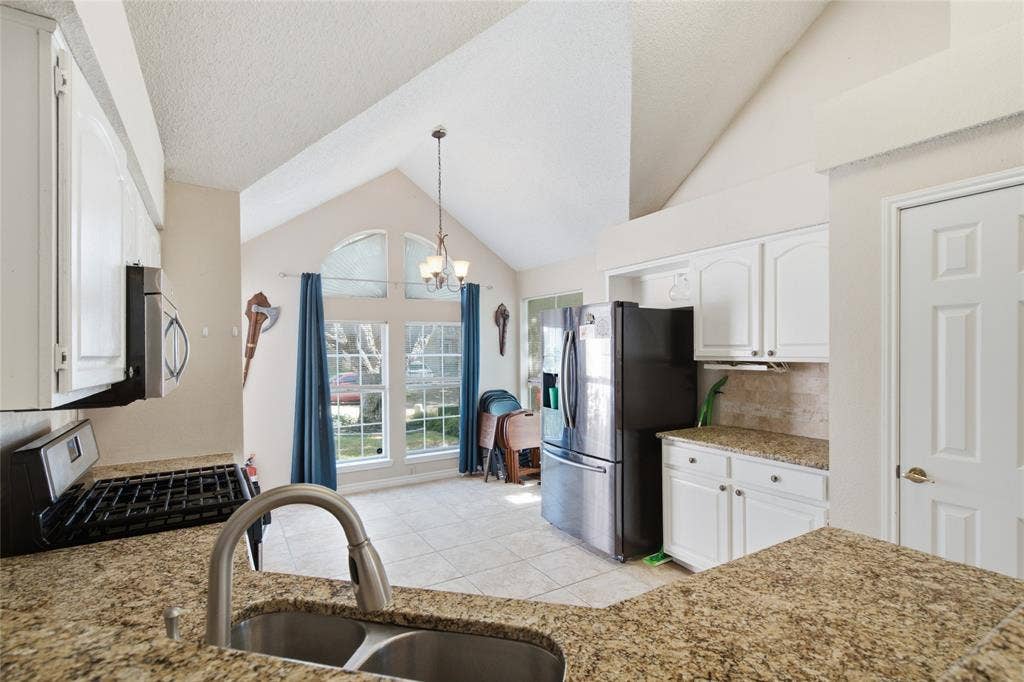 1106 Cain Court, Cedar Hill, TX 75104 Kitchen featuring granite-style countertops, white cabinetry, and stainless-steel appliances