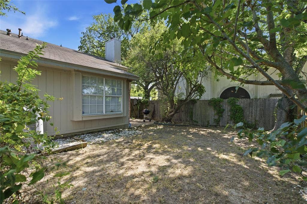 1106 Cain Court, Cedar Hill, TX 75104 Rear exterior with tan siding and a pitched roofline