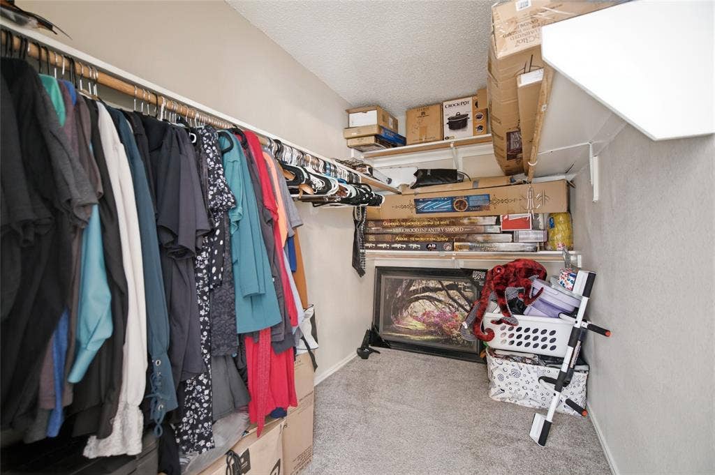 1106 Cain Court, Cedar Hill, TX 75104 Carpeted closet space featuring a built-in hanging rod, wall shelving, and neutral wall tones