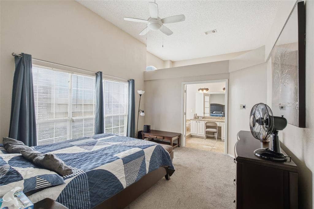 1106 Cain Court, Cedar Hill, TX 75104 Carpeted room featuring a vaulted ceiling and a ceiling fan
