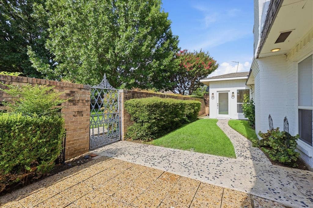 4310 Forest Bend Road, Dallas, TX 75244 White brick exterior with a pebble-dash pathway leading to the entry