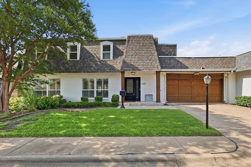 4310 Forest Bend Road, Dallas, TX 75244 White exterior with a prominent brown shingle roof and dormer windows