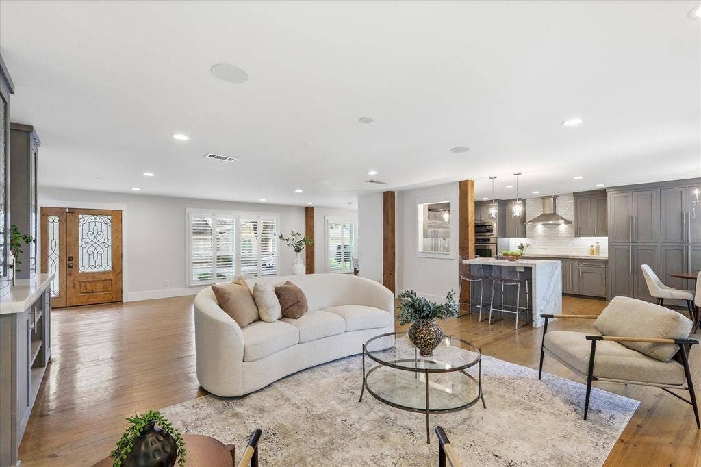 4310 Forest Bend Road, Dallas, TX 75244 Open-concept living area featuring hardwood flooring, recessed lighting, and a kitchen with an island, pendant lighting, and grey cabinetry