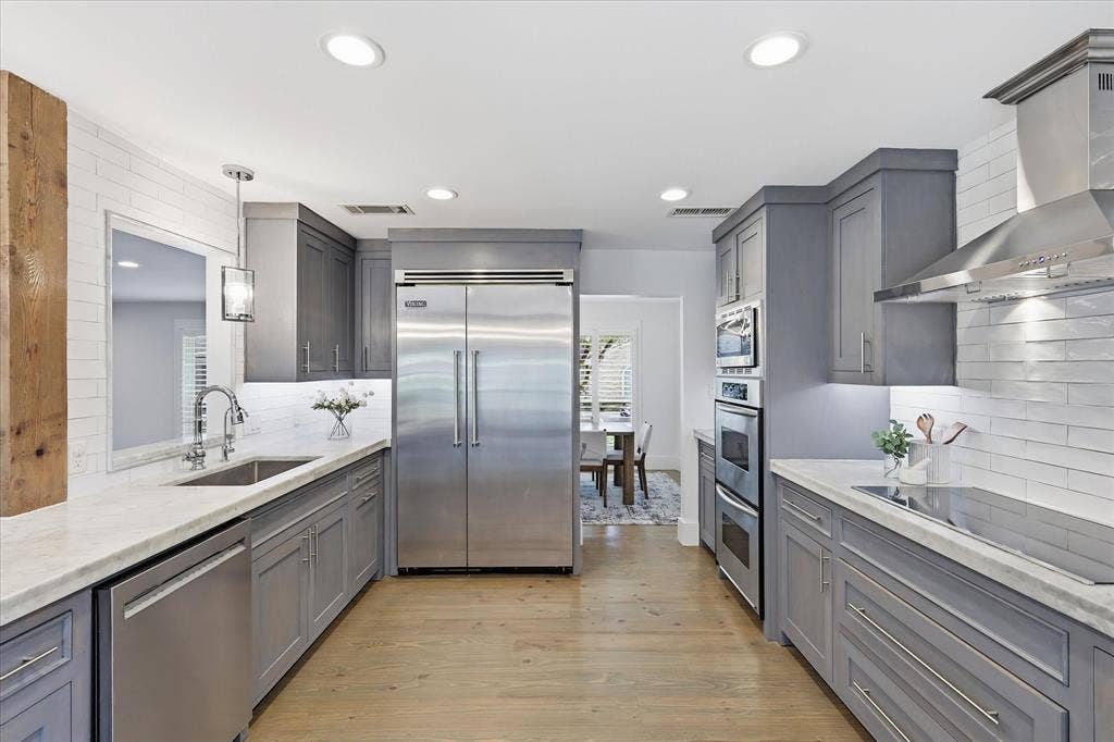 4310 Forest Bend Road, Dallas, TX 75244 Galley kitchen featuring light wood-finish flooring, recessed lighting, and a neutral color palette