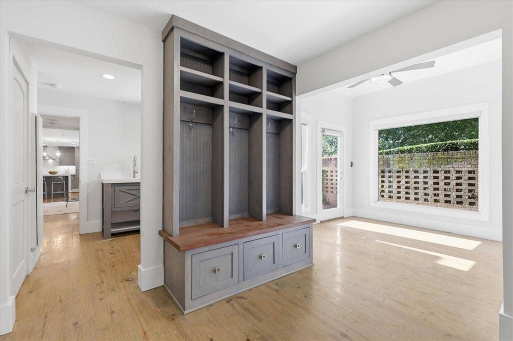 4310 Forest Bend Road, Dallas, TX 75244 Built-in mudroom storage featuring bench seating, storage compartments, and coat hooks