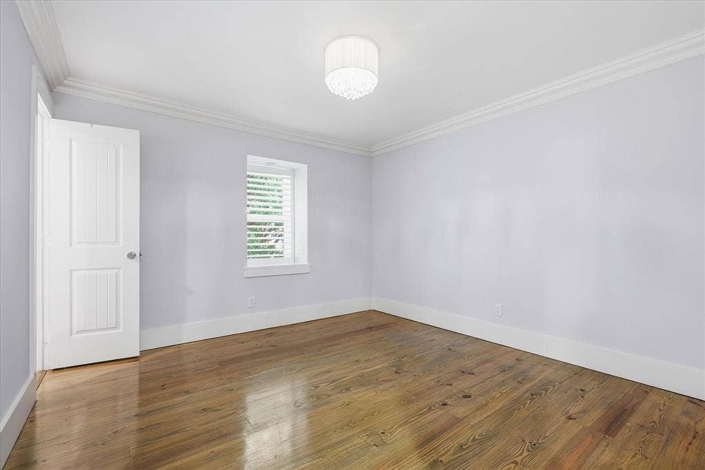 4310 Forest Bend Road, Dallas, TX 75244 Bright room featuring wood-finish flooring, white baseboards, crown molding, a window with horizontal blinds, and a semi-flush mount ceiling light fixture