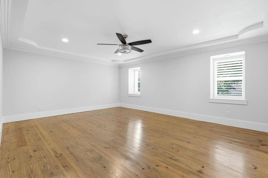 4310 Forest Bend Road, Dallas, TX 75244 Spacious room featuring hardwood flooring, tray ceiling with recessed lighting, and a ceiling fan