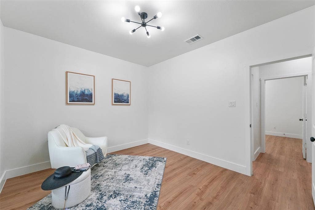 117 Parkside Drive, Trinidad, TX 75163 Bright interior space featuring wood-finish flooring, a contemporary ceiling light fixture, white walls, and white baseboards