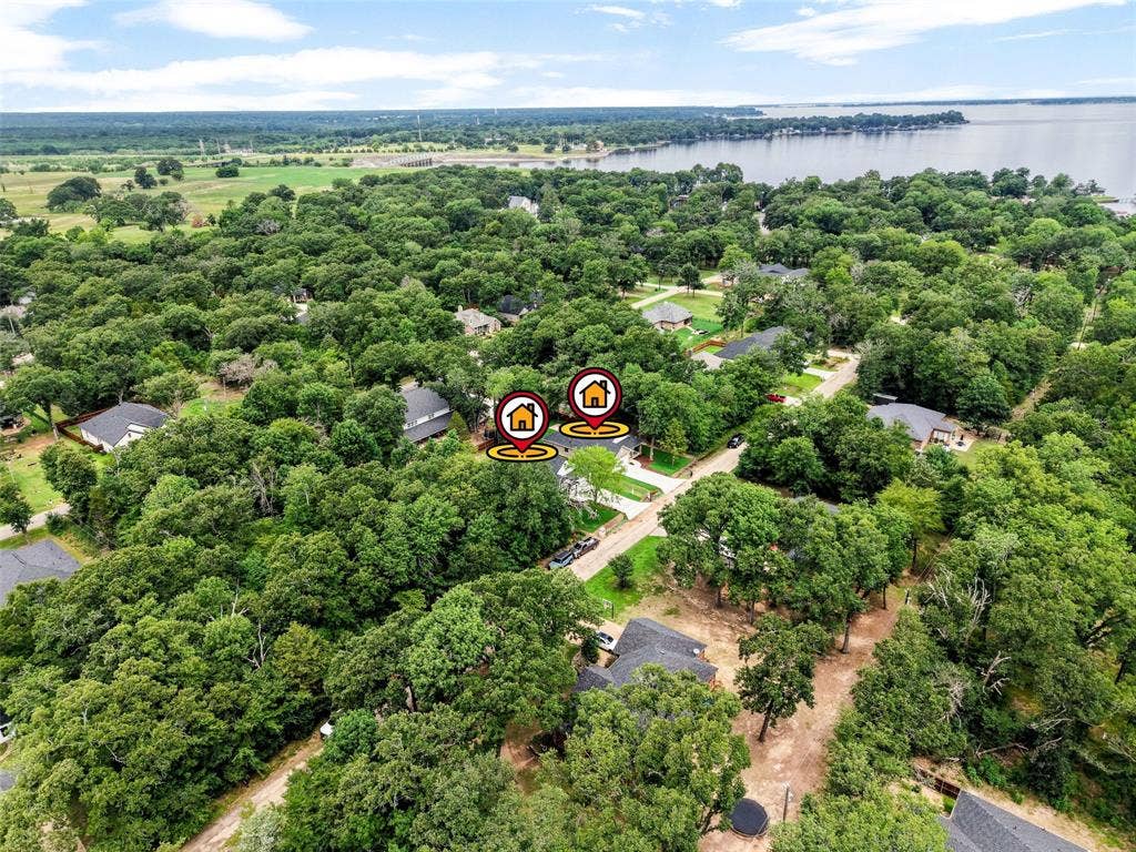 117 Parkside Drive, Trinidad, TX 75163 Aerial perspective showcasing residential properties nestled among extensive tree cover, with a body of water in the background