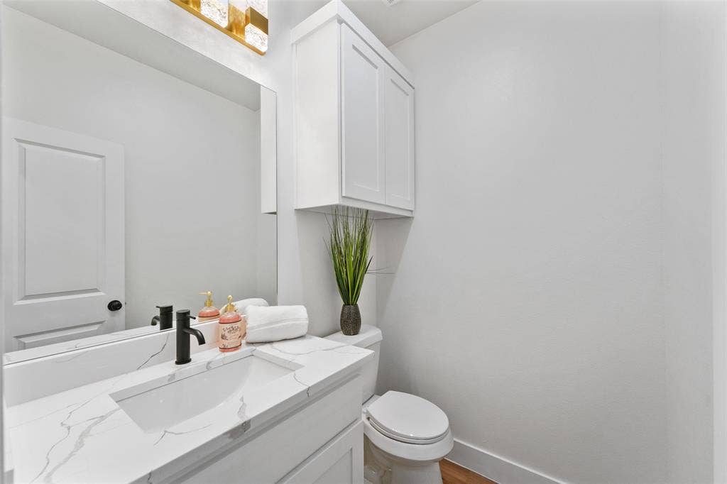 117 Parkside Drive, Trinidad, TX 75163 White vanity with a rectangular undermount sink, a white countertop with grey veining, and a matte black faucet