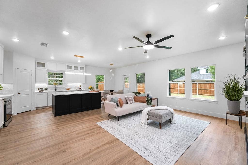 117 Parkside Drive, Trinidad, TX 75163 Open-concept living area featuring wood-finish flooring throughout, a modern ceiling fan, and recessed lighting