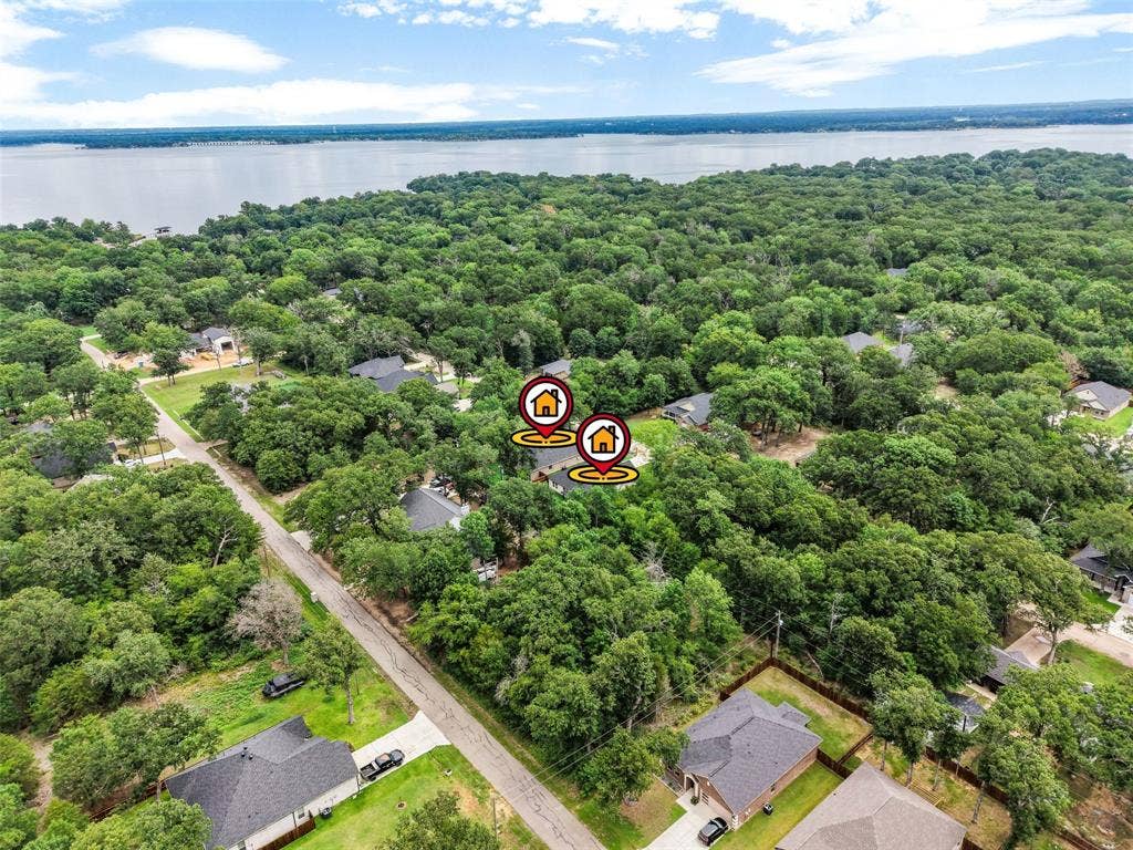 117 Parkside Drive, Trinidad, TX 75163 Aerial view showcasing a residential area with dense tree coverage and proximity to a large body of water