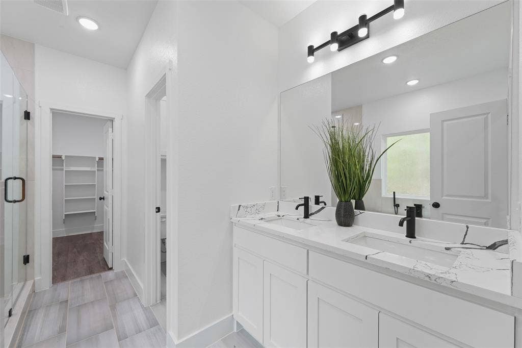 122 E Beachwood Loop, Trinidad, TX 75163 Dual vanity with integrated rectangular sinks, stone-finish countertops, and matte black fixtures