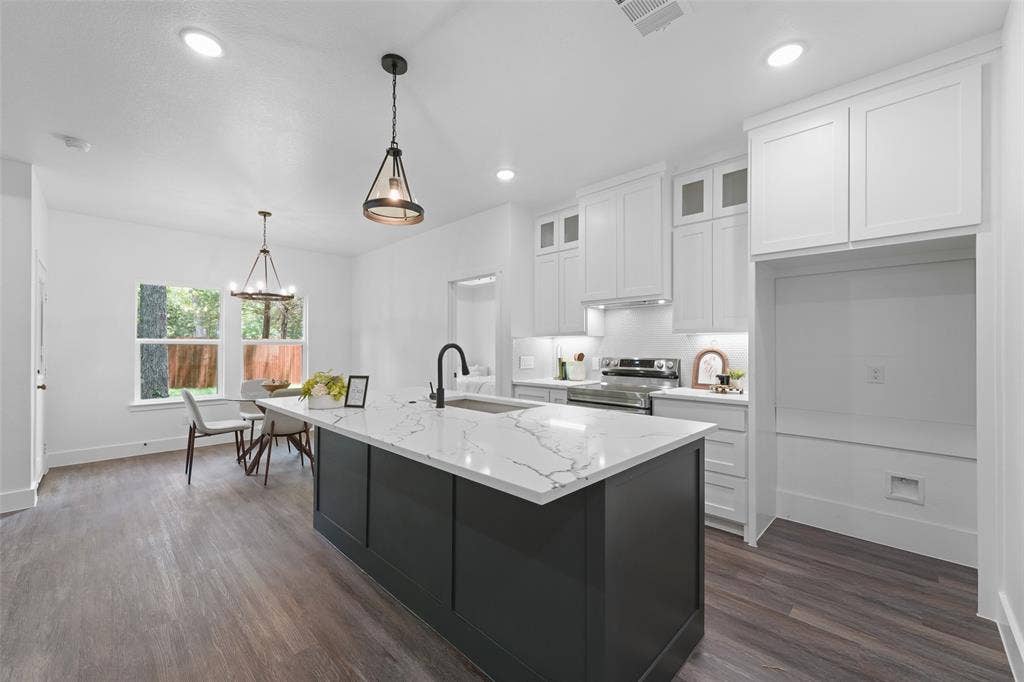 122 E Beachwood Loop, Trinidad, TX 75163 Kitchen featuring an expansive island with a stone countertop, dark cabinetry, and integrated sink