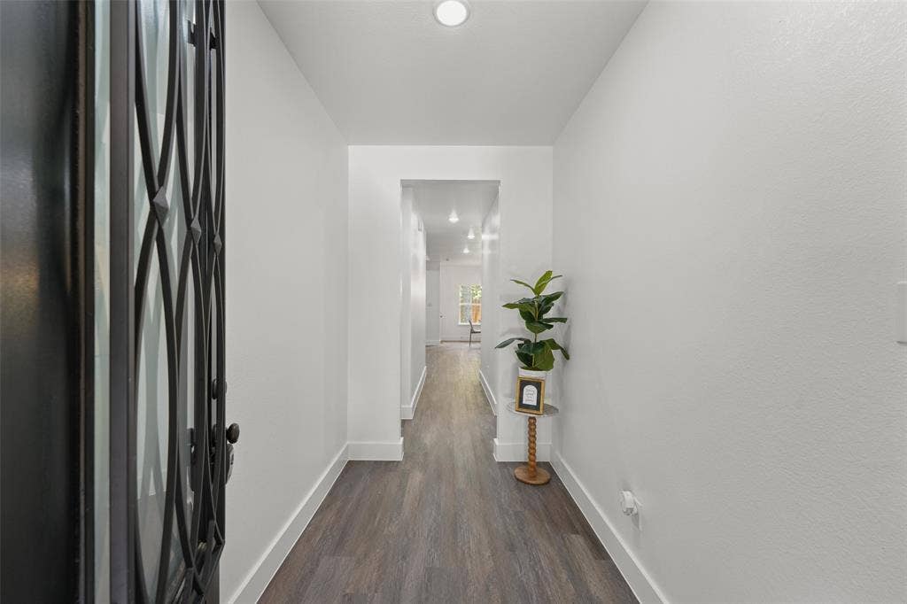 122 E Beachwood Loop, Trinidad, TX 75163 Entryway featuring a dark metal door with decorative ironwork, white walls, wood-finish flooring, recessed lighting, and white baseboards