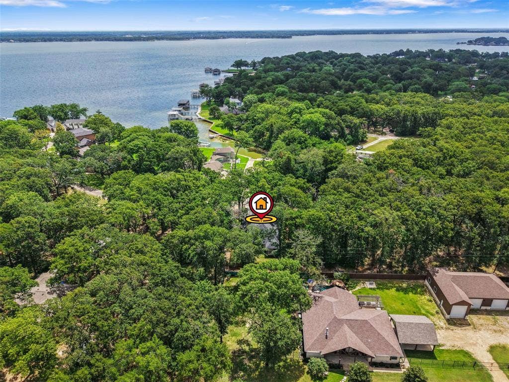 231 E Beachwood Loop, Trinidad, TX 75163 Extensive wooded property with a prominent water feature in the background
