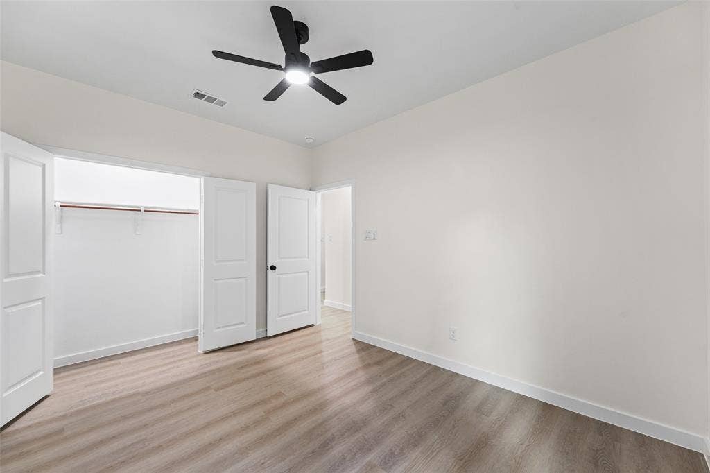 231 E Beachwood Loop, Trinidad, TX 75163 Interior room featuring wood-finish flooring and a black ceiling fan with integrated lighting
