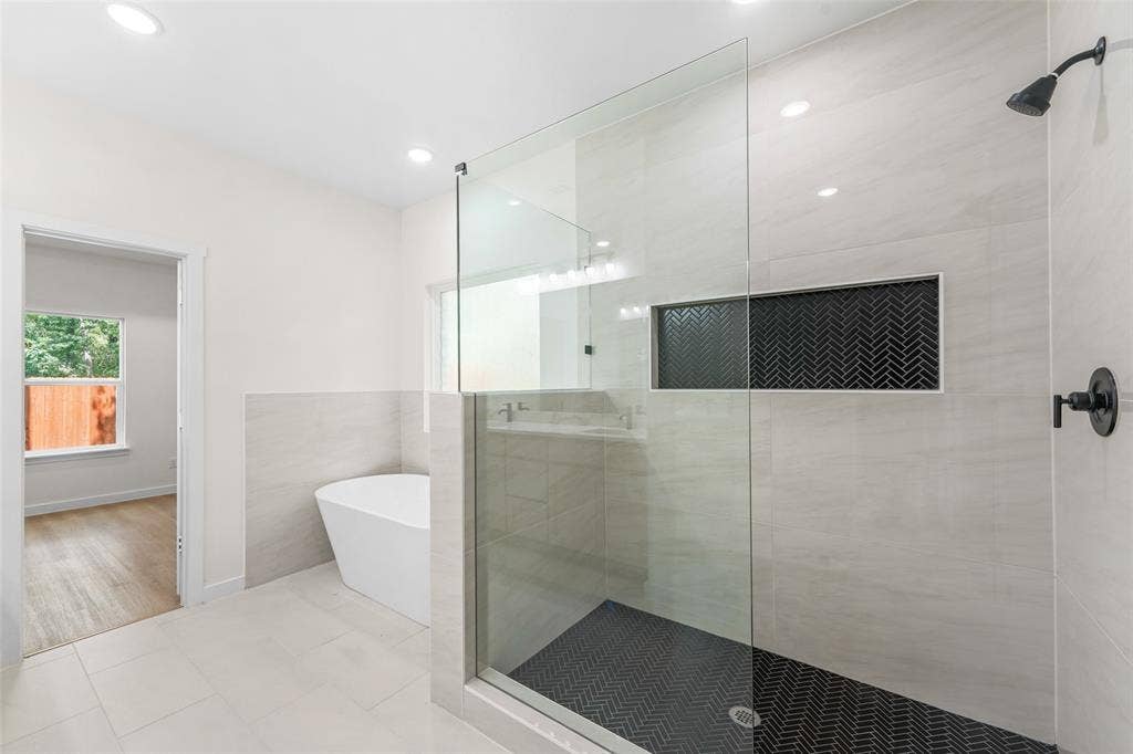 231 E Beachwood Loop, Trinidad, TX 75163 Modern bathroom featuring a frameless glass shower enclosure and a freestanding soaking tub