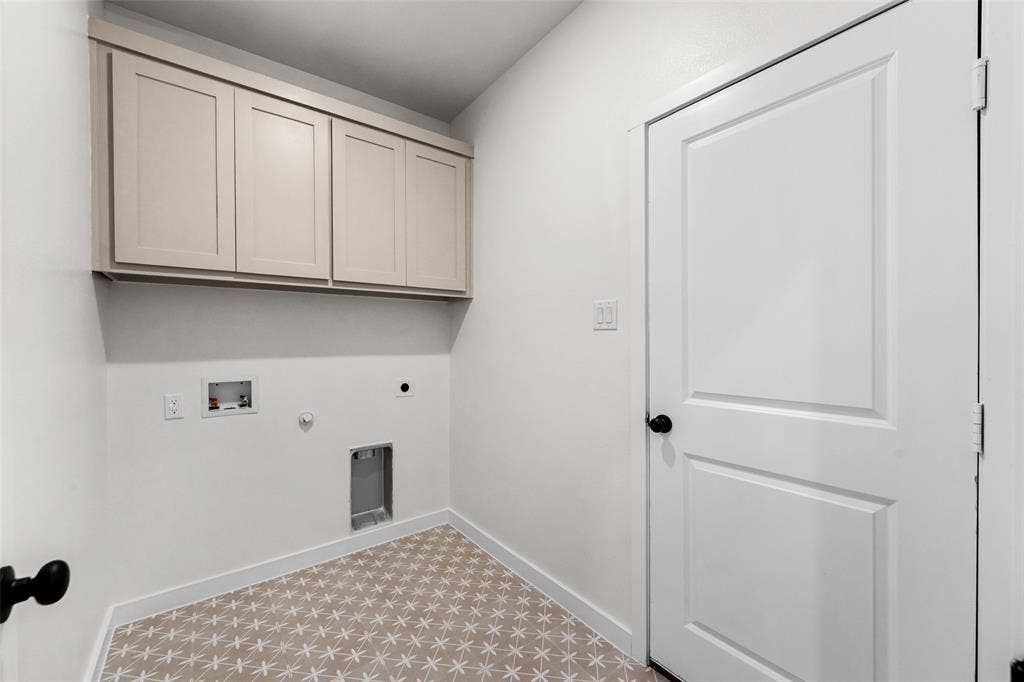 231 E Beachwood Loop, Trinidad, TX 75163 Utility space featuring neutral wall paint, patterned floor tile, and upper cabinetry
