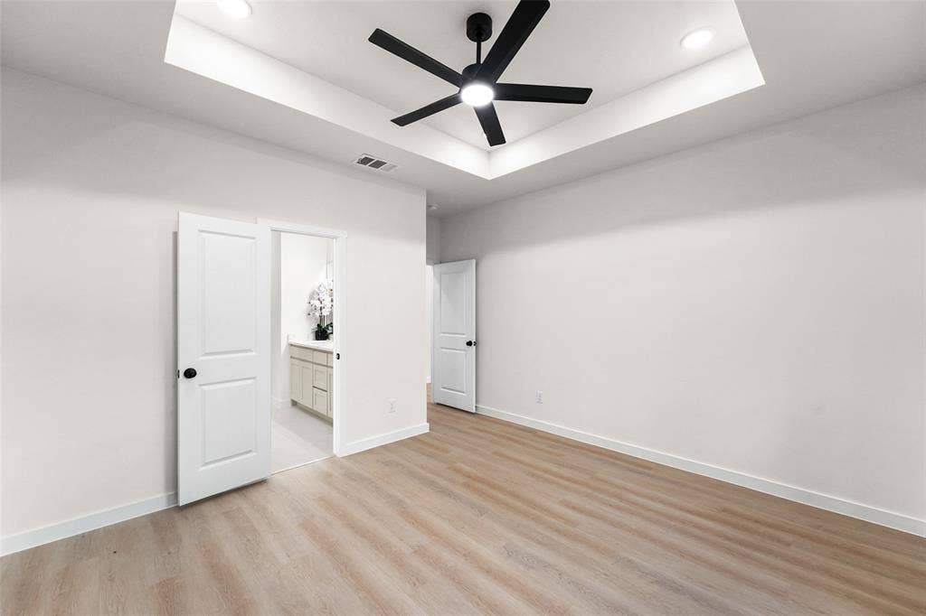 231 E Beachwood Loop, Trinidad, TX 75163 Spacious interior room featuring wood-finish flooring, a tray ceiling with recessed lighting, and a contemporary ceiling fan